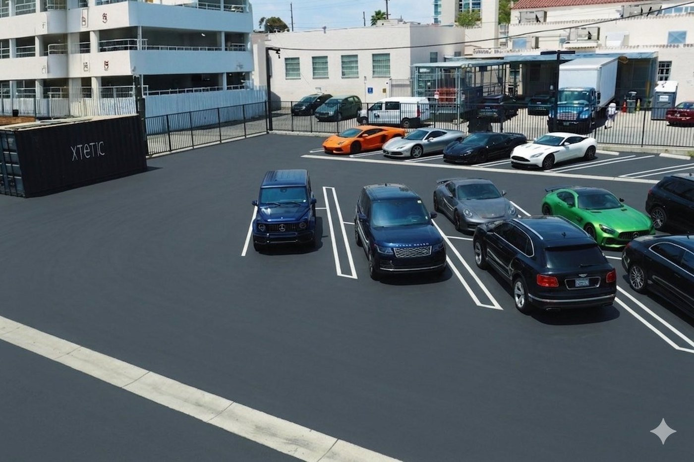 Private gated parking lot with exotic vehicles parked in front of the Xtetic Academy facility