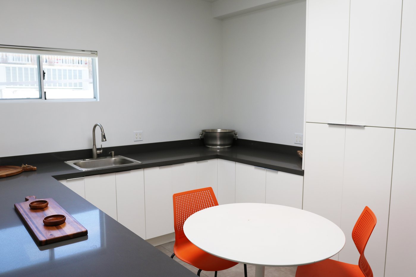 Prep kitchen with sink, counter space, and dining table